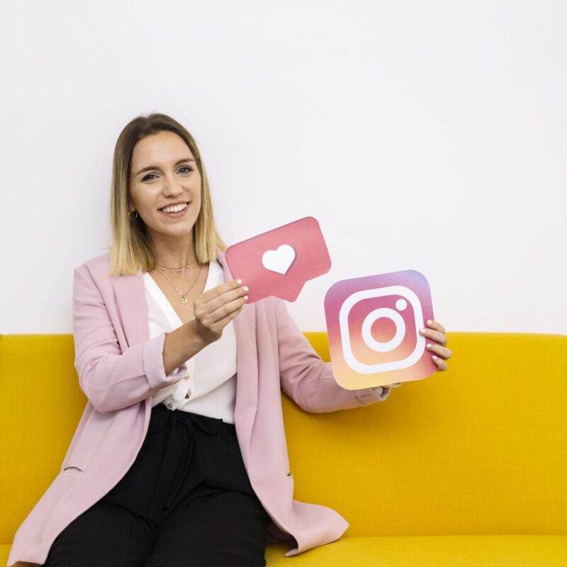 confident-young-woman-holding-instagram-like-icon-scaled.jpg